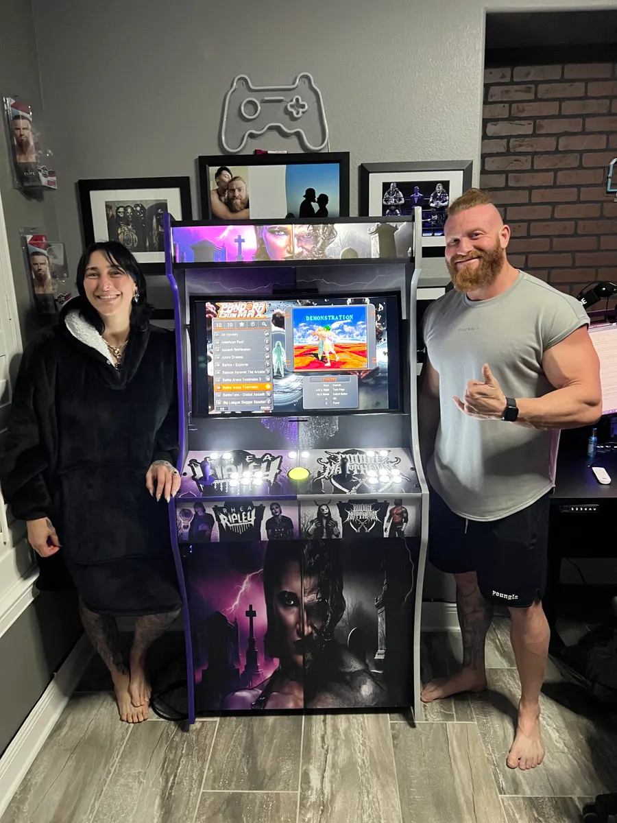 Rhea Ripley & Buddy Matthews with the Dark Union arcade